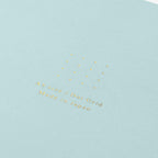 Midori A5 blue dot grid notebook with pen on desk