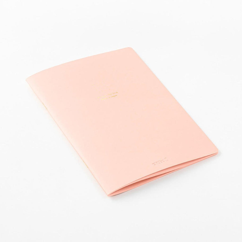 Midori A5 pink dot grid notebook open showing pages
