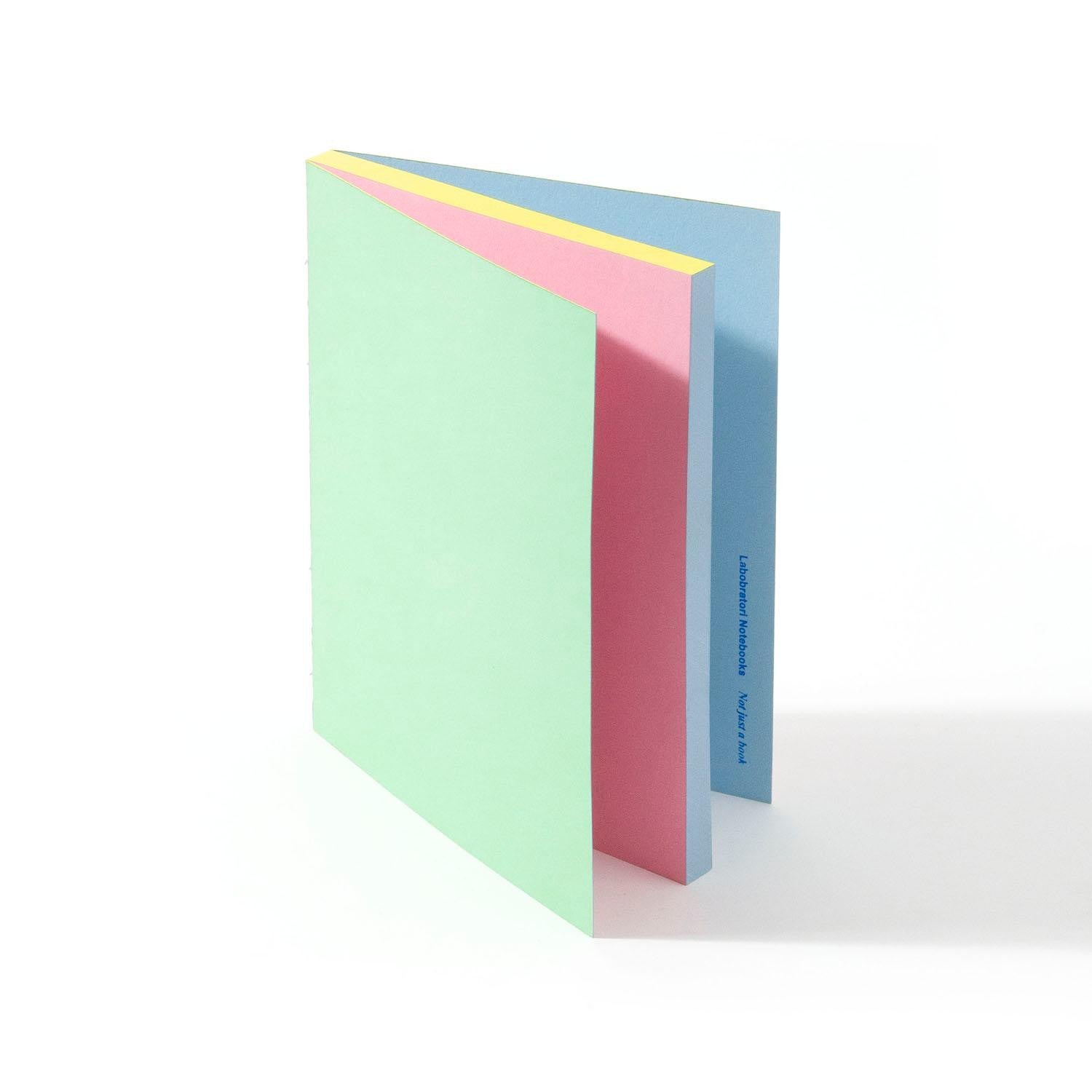 Labobratori sprayed edge notebook pink green open showing pages