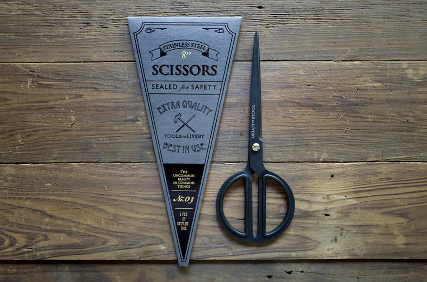 Tools to Liveby black scissors with notebook flat lay