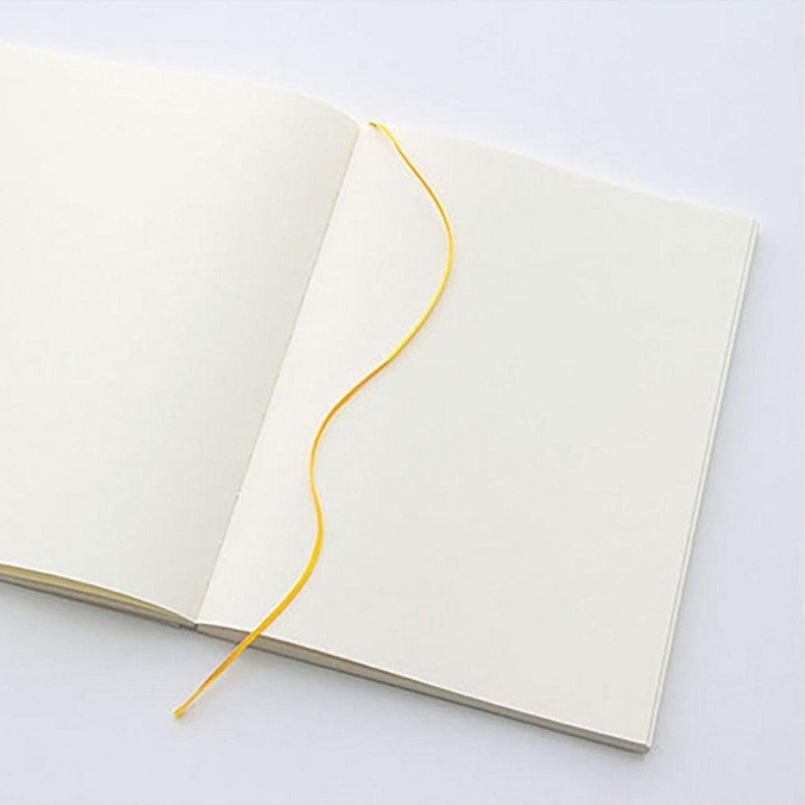 Midori MD Paper A5 notebook with pen on desk