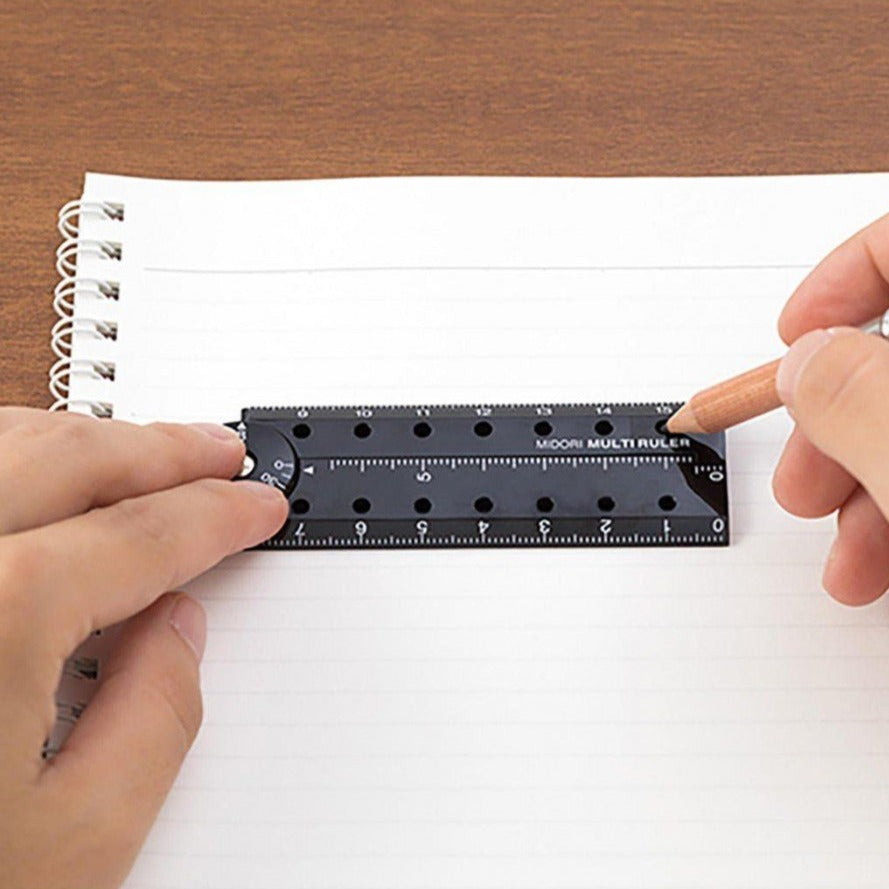 Midori multi ruler 16cm black in use on notebook