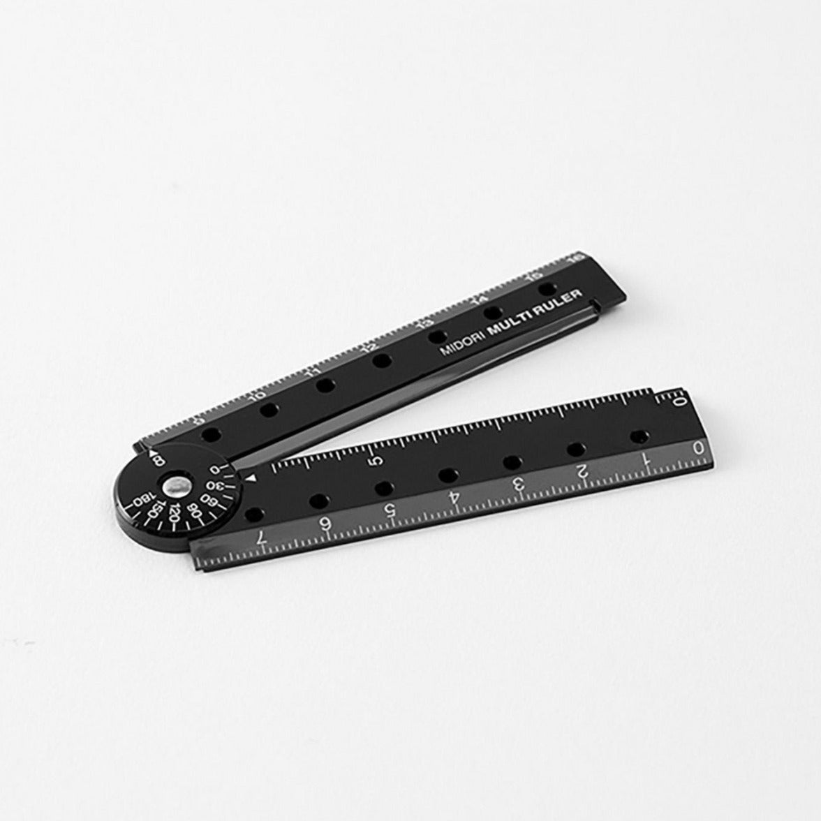 Midori 16cm black ruler with notebook flat lay