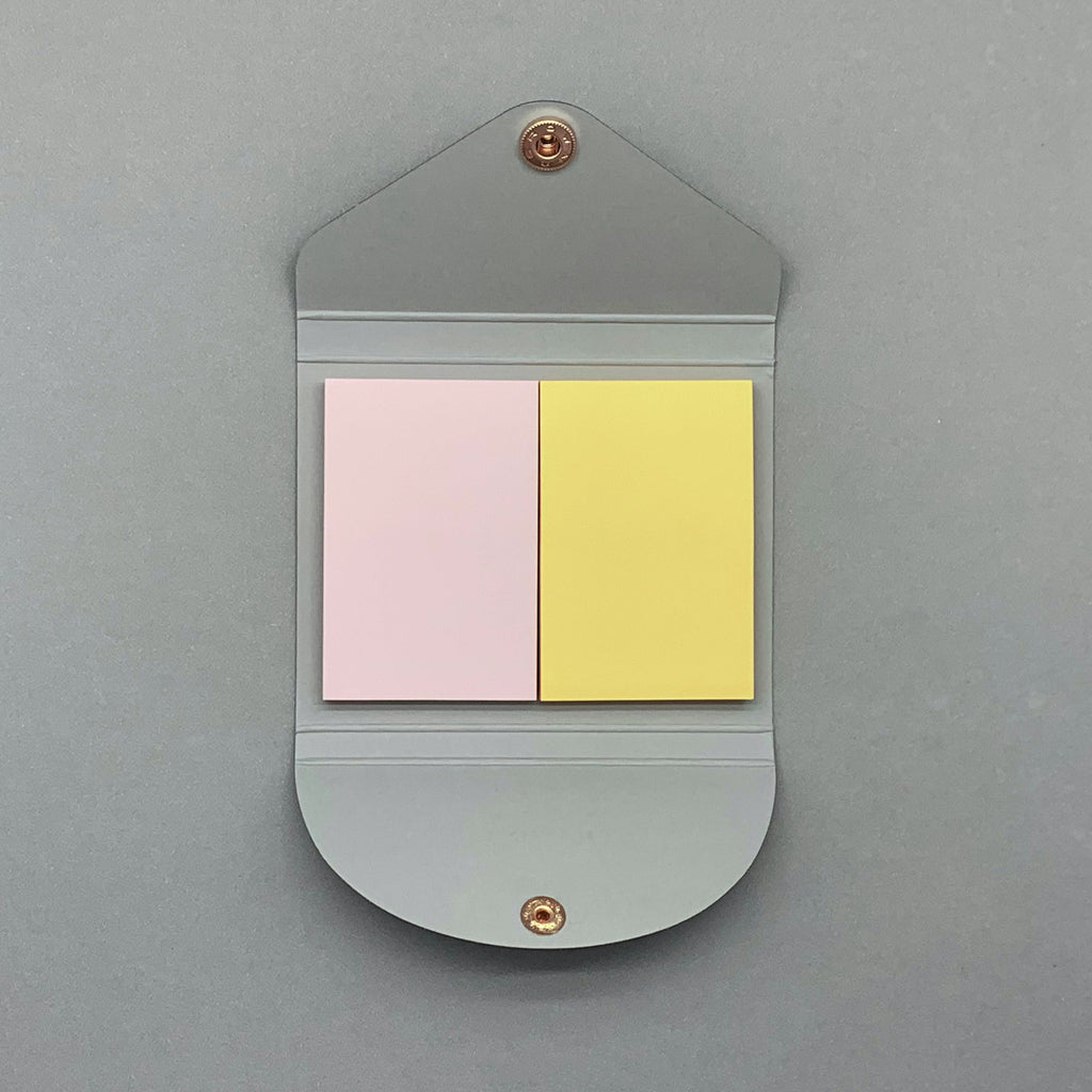 Navy sticky notes cover open showing coloured pages