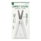Midori white compact retractable scissors in hand